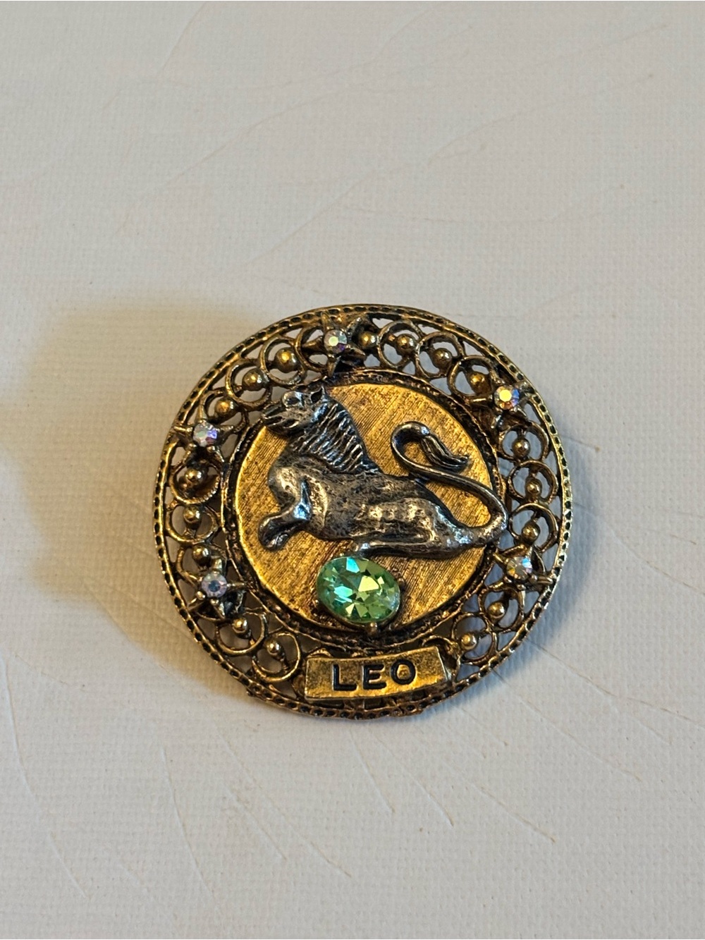 Gold-Tone Leo Brooch with Green Crystal Accent